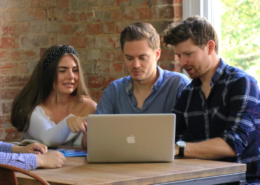3 ppc people colleagues having a meeting looking at a laptop screen